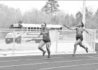 BEE PHOTO / TONI WALKER Joi Akinsuroju takes the hand-off from Zamya Wilbarger in the 800 meter relay during the Mickey Mayne Relays on March 23. The Lady Tigers placed third in the relay in route to a second palce overall finish. Article Image Alt Text