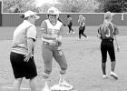 Lady Mustang Shea Nelson gets instruction from Hughes Springs Head Coach Tisha Thompson after making it safely to third during March 12 action against Daingerfield. Article Image Alt Text