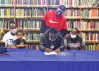Zaylon Jeter, center, signs a letter of intent to play football at Texas College Feb. 3. With Jeter is his mom, Tonya Jeter, son Isaac Jeter, Uncle Reggie Jeter, and Aunt Ashley Searcy. National Signing Day