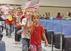 Second grade students from Diangerfield’s West Elementary School enter the D-LS ISD Veterans Day Program waving American Flags as fifth graders (not pictured) sang “ You’re a Grand Old Flag.” BEE PHOTOS / TONI WALKER Duty, Honor, Country