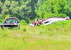 The wreckage of a single engine Piper PA-32 rests near the tree line at the Mount Pleasant Regional Airport July 3. The crash killed prominent Omaha resident Jere Kellough. COURTESY PHOTO Article Image Alt Text