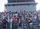 Hughes Springs graduating Seniors, led by their honor guard, coming down the stadium stairwell between the cheering crowd
