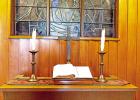 A Bible lays open at the front of the chapel