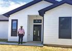 Earnest Woods stands in front of the first house being built in Woods Estates
