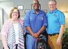 Chamber Executive Director Judi Howell, left, and Atlas Roofing Purchasing Specialist Wade Kerly, right, present Morris County Sheriff Jack Martin with gifts of appreciation during a Law Enforcement Appreciation Lunch held June 25. Daingerfield Chamber honors Daingerfield