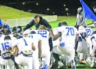 Daingerfield Head Coach Davin Nelson and his team pray before kickoff of Thursday’s state semifinal game against Tidehaven. Daingerfield’s quest for a seventh state title ended with a 20-14 overtime loss, concluding the Tigers’ season at 11-4. BEE P Daingerfield’s run ends in overtime at state semifinals