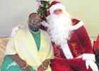 Gean Ellison, left, is pictured with Santa (John Satterfield) during a toy drive and visit with Santa held Dec. 20. The event was put on by Love Chapel and the Traylor Civic Center. COURTESY PHOTO Local residents host visit with Santa