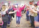 COURTESY PHOTO Brandi Turnage Williams, center in pink, is surrounded by family and friends following her final chemotherapy treatment at Baylor Hospital. The group traveled in support of Williams in her fight against breast cancer. Survivor Stories: Attitude is Everything