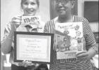COURTESY PHOTO Gloria Roney, right, of West Elementary School in Daingerfield accepts a Distinguished Merit Award from Lifetouch from Kim Weaver during a workshop in Tyler on Feb. 7. Roney accepted the award on behalf of the school’s 2018 yearbook staff Article Image Alt Text