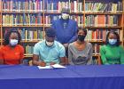Trayvon Kennedy, second from left, is joined by his family as he signs a letter of intent to play football at Kilgore College. Seated with Kennedy is Adrianna Kennedy, Yuvonda Brown, and Autumn Everett. Standing is Marcus Brown. National Signing Day